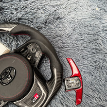 Cargar imagen en el visor de la galería, Volante de fibra de carbono TTD Craft para Toyota Supra MK5 A90 A91 (2020-2025)